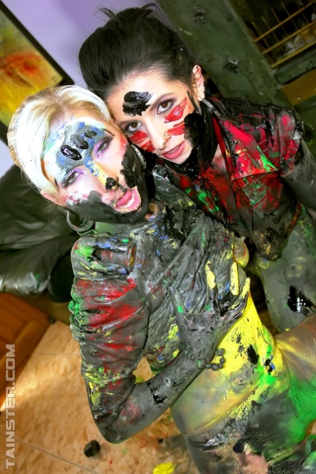 Clothed women cover each other from head to toe in body paint 93580202